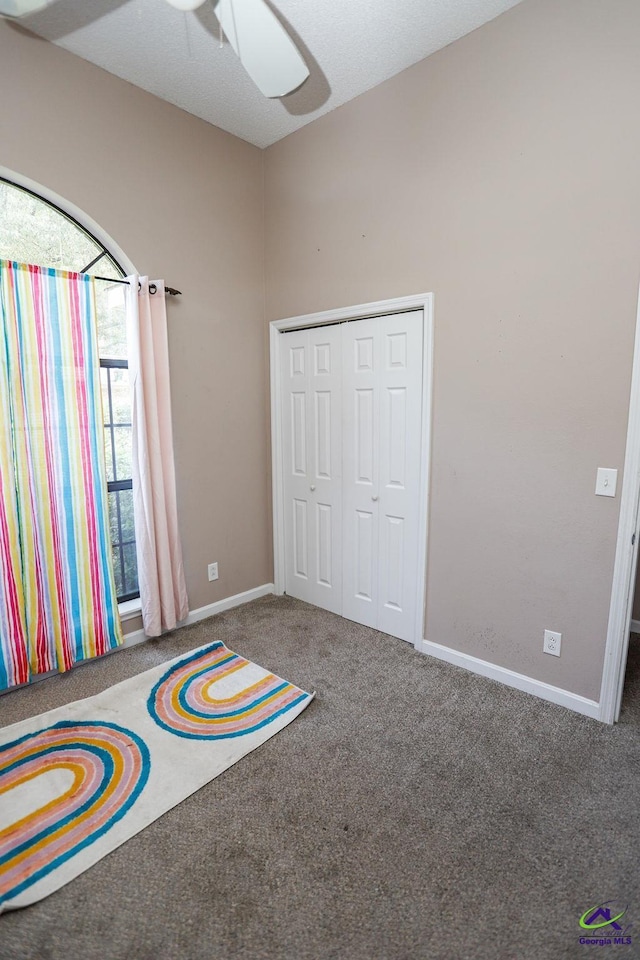 209 Ridgestone, Warner Robins, GA 31088 - unfurnished bedroom with carpet, baseboards, a closet, and ceiling fan