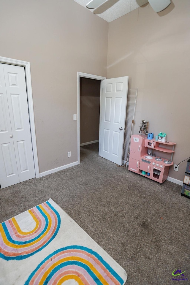 209 Ridgestone, Warner Robins, GA 31088 - bedroom with carpet, baseboards, a towering ceiling, and a ceiling fan