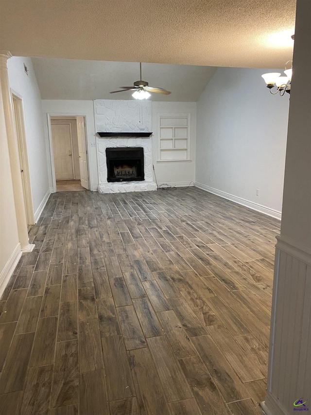 310 Westcliff Ctr, Warner Robins, GA 31088 - unfurnished living room featuring dark wood finished floors, ceiling fan, a stone fireplace, baseboards, and lofted ceiling