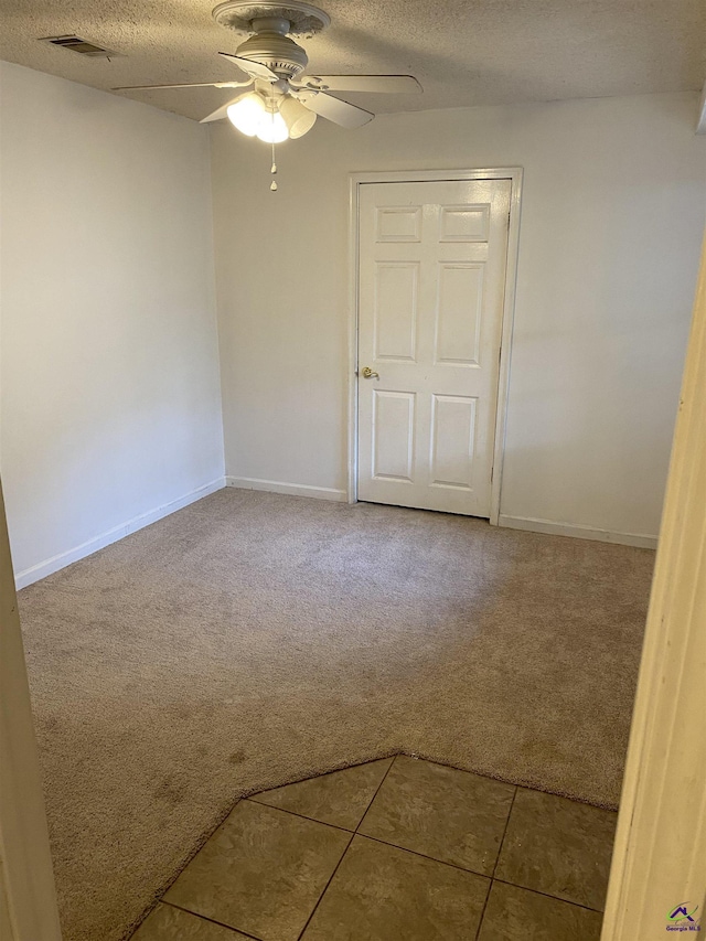 310 Westcliff Ctr, Warner Robins, GA 31088 - unfurnished room featuring carpet floors, ceiling fan, a textured ceiling, baseboards, and tile patterned floors