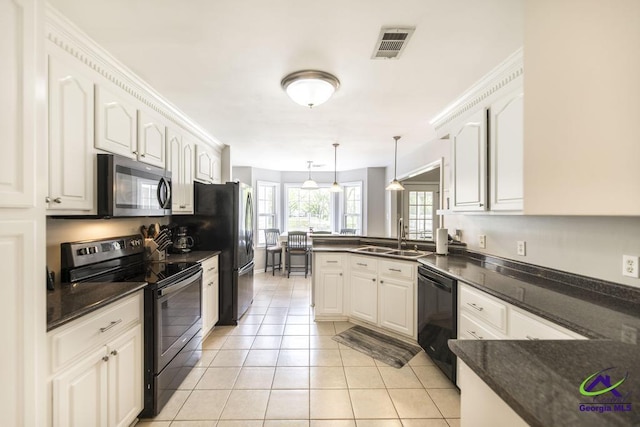 kitchen featuring black appliances, a sink, a peninsula, and white cabinetry