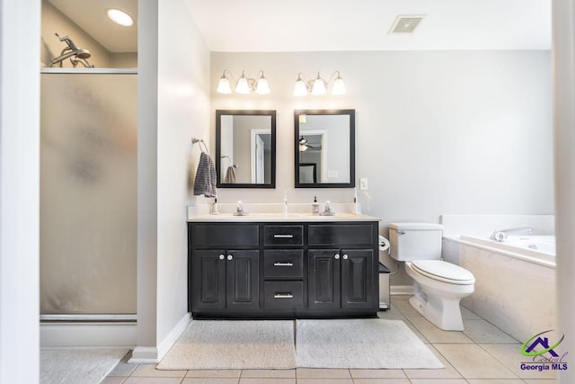 bathroom featuring tile patterned flooring, a stall shower, double vanity, toilet, and a garden tub