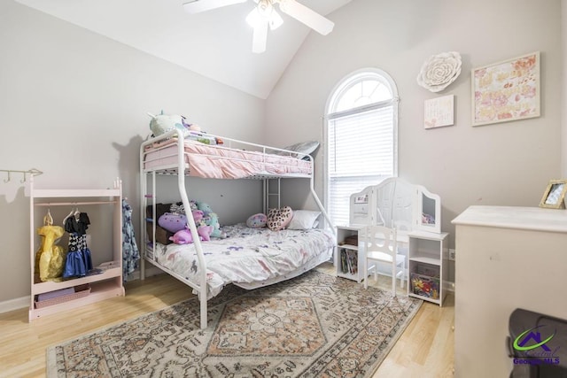 bedroom featuring wood finished floors, vaulted ceiling, and a ceiling fan