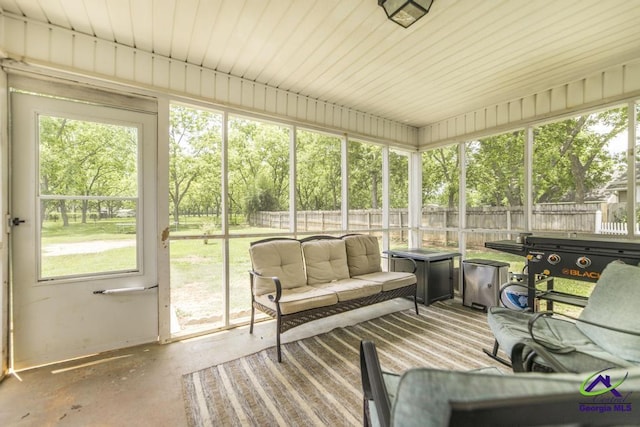 sunroom featuring healthy amount of natural light and an outdoor living space