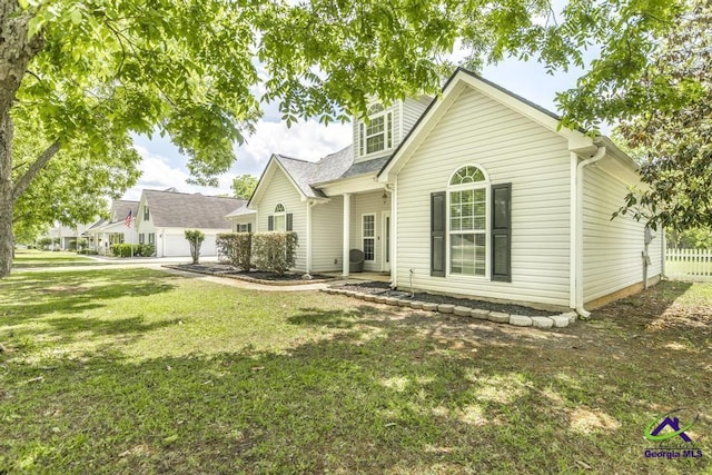 back of property featuring roof with shingles and a yard