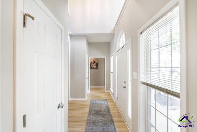 entrance foyer with light wood-style flooring and baseboards