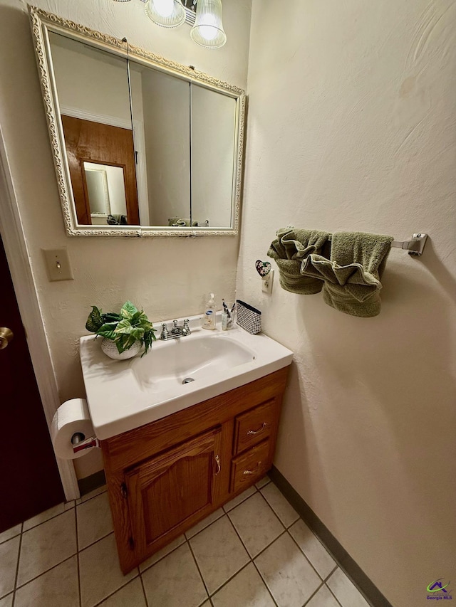 bathroom featuring tile patterned flooring, vanity, and baseboards