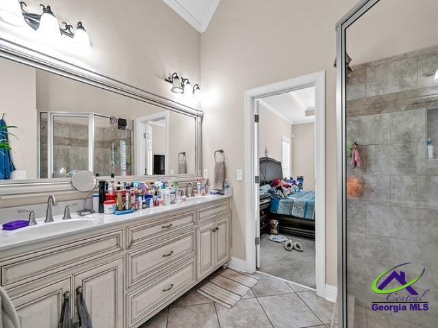 163 Broadleaf Dr, Macon, GA 31210 - ensuite bathroom featuring a stall shower, ornamental molding, double vanity, tile patterned flooring, and baseboards