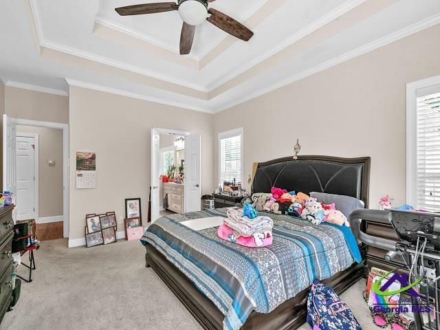 163 Broadleaf Dr, Macon, GA 31210 - bedroom featuring a tray ceiling, crown molding, carpet floors, baseboards, and ceiling fan