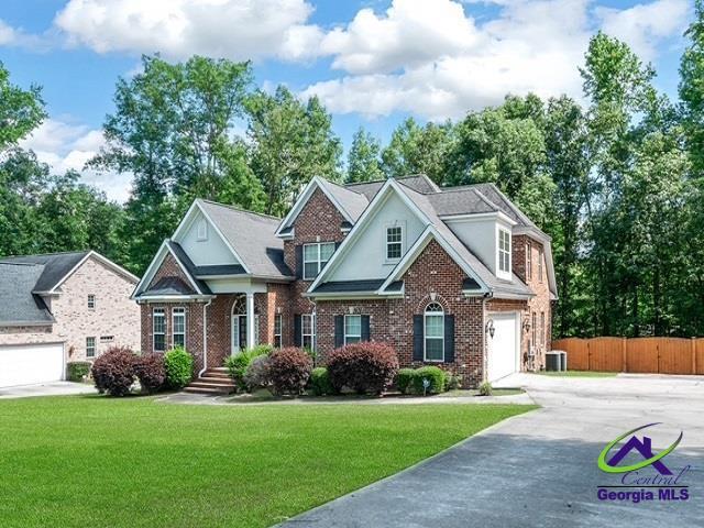163 Broadleaf Dr, Macon, GA 31210 - view of front facade with driveway, brick siding, and a garage