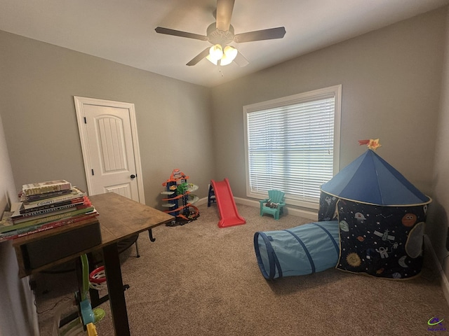 rec room featuring carpet flooring and a ceiling fan