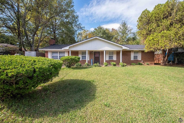 111 Briarwood Dr, Warner Robins, GA 31093 - ranch-style house with brick siding, a front lawn, a chimney, and covered porch