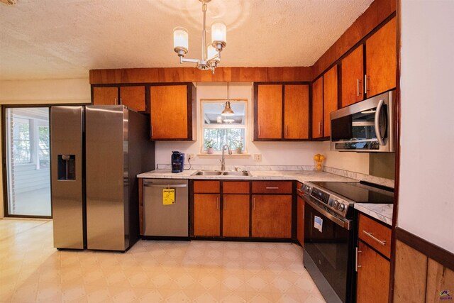 111 Briarwood Dr, Warner Robins, GA 31093 - kitchen featuring stainless steel appliances, a sink, a textured ceiling, plenty of natural light, and light flooring