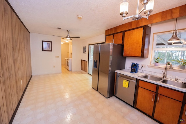 111 Briarwood Dr, Warner Robins, GA 31093 - kitchen with stainless steel appliances, a sink, light floors, washing machine and dryer, and light countertops
