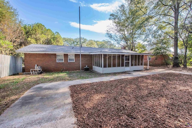 111 Briarwood Dr, Warner Robins, GA 31093 - rear view of property featuring a sunroom, brick siding, and fence