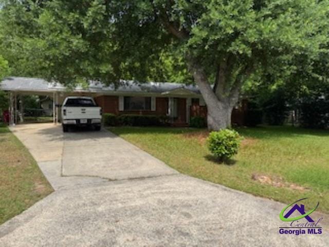 111 Mason Dr, Centerville, GA 31028 - view of front of home featuring concrete driveway, a front yard, and a carport