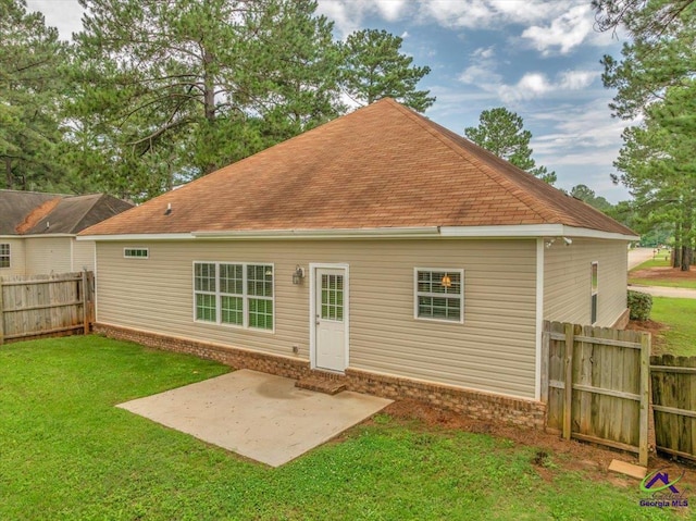 back of house with a patio and roof with shingles