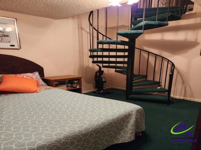 29 Riverview Dr, Hawkinsville, GA 31036 - carpeted bedroom featuring a textured ceiling and baseboards