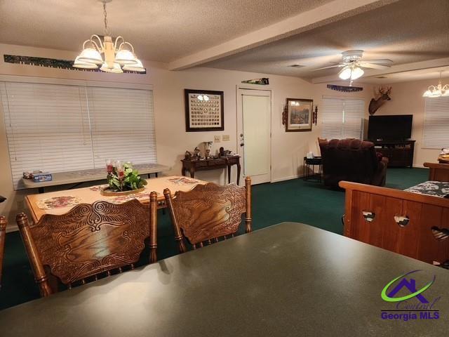 29 Riverview Dr, Hawkinsville, GA 31036 - dining space featuring a chandelier, ceiling fan, beamed ceiling, and carpet