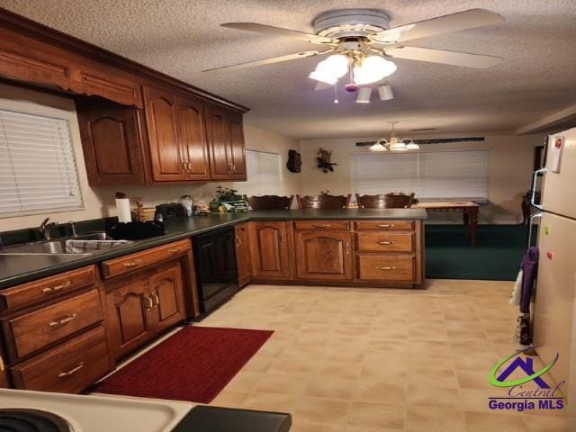 29 Riverview Dr, Hawkinsville, GA 31036 - kitchen with dishwasher, a sink, dark countertops, a peninsula, and a ceiling fan