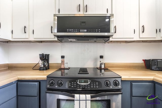 kitchen featuring appliances with stainless steel finishes, decorative backsplash, white cabinetry, and blue cabinetry