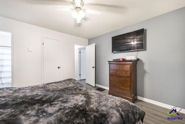 bedroom with wood finished floors, baseboards, and a ceiling fan