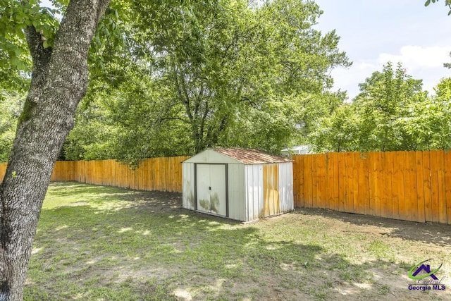 view of yard featuring a storage shed and an outbuilding