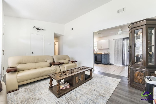 living room with ceiling fan, light wood-type flooring, and plenty of natural light