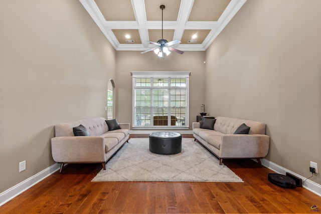living area with dark wood-style floors, a ceiling fan, baseboards, crown molding, and beamed ceiling