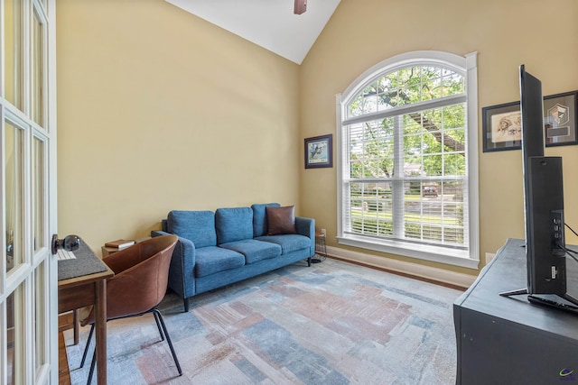 living room featuring high vaulted ceiling and ceiling fan