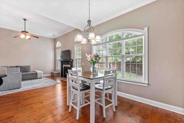dining space featuring ornamental molding, plenty of natural light, baseboards, and hardwood / wood-style floors