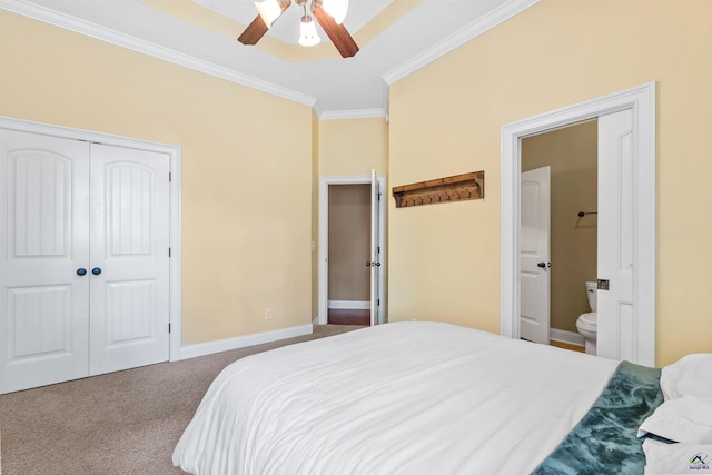 bedroom with crown molding, carpet flooring, a closet, ensuite bathroom, and ceiling fan