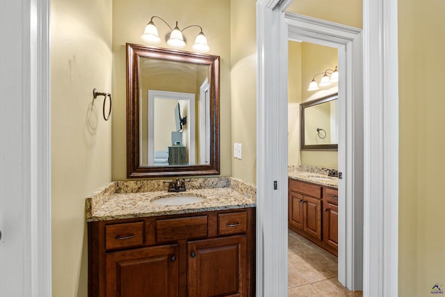 bathroom featuring two vanities and tile patterned flooring