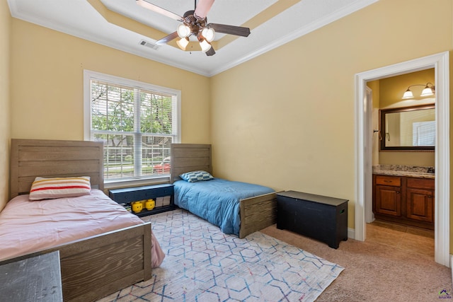bedroom with ornamental molding, light carpet, connected bathroom, and a ceiling fan