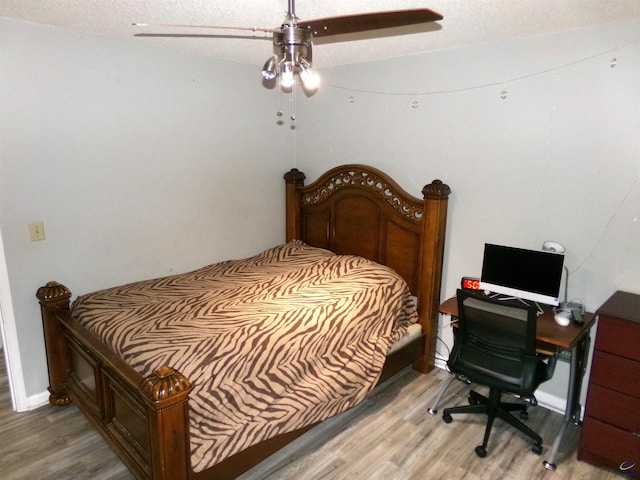 871 Chisholm Trl, Macon, GA 31220 - bedroom with light wood finished floors, a textured ceiling, a ceiling fan, and baseboards