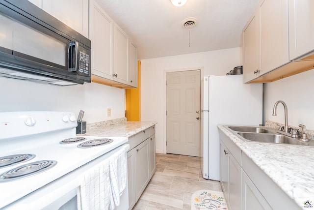 22 Waterford Way, Hawkinsville, GA 31036 - kitchen with white appliances, a sink, light countertops, and stone finish floors