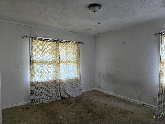unfurnished room featuring carpet flooring, a textured ceiling, and baseboards
