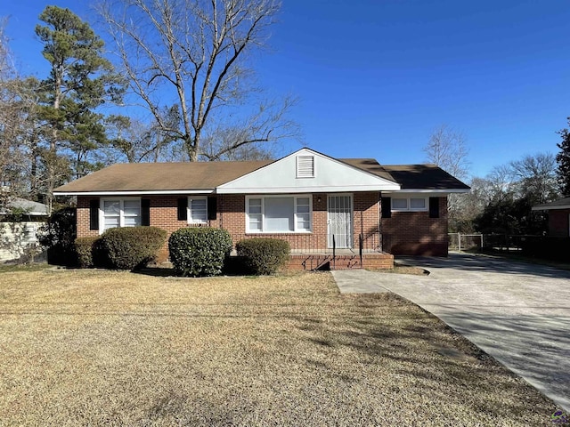 single story home featuring brick siding