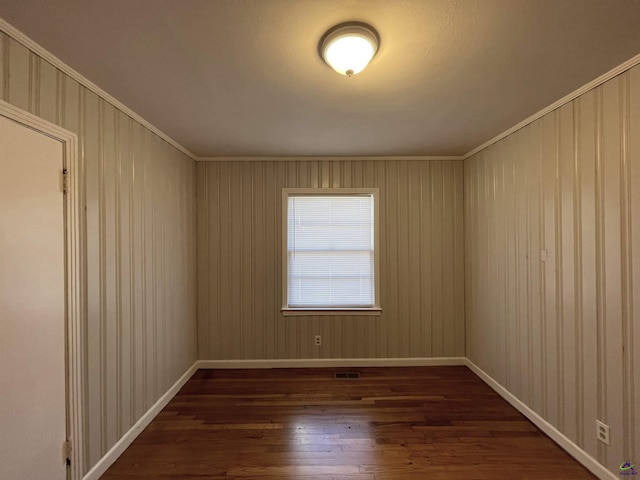 empty room with dark wood-style floors and baseboards