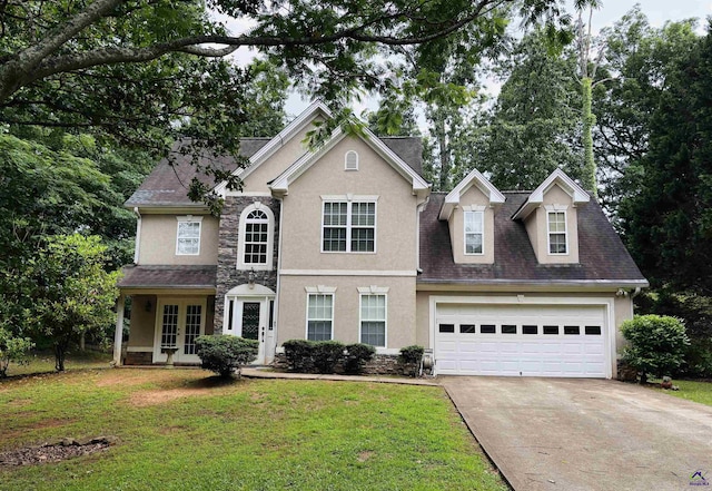 traditional home with french doors, stucco siding, driveway, and a front yard