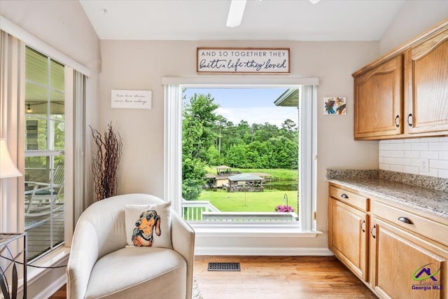 living area featuring light wood-style floors and baseboards