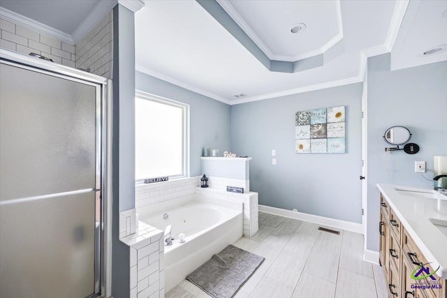 full bathroom featuring crown molding, a shower stall, a tub with jets, double vanity, and baseboards