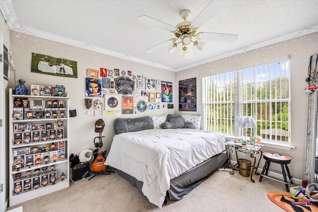 carpeted bedroom with ornamental molding, a textured ceiling, and a ceiling fan
