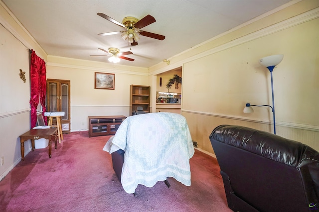 bedroom with carpet, ornamental molding, and a ceiling fan