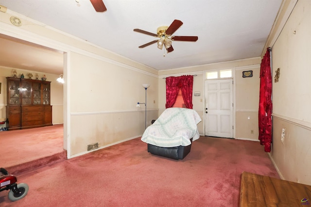 living area featuring a ceiling fan, carpet, and ornamental molding
