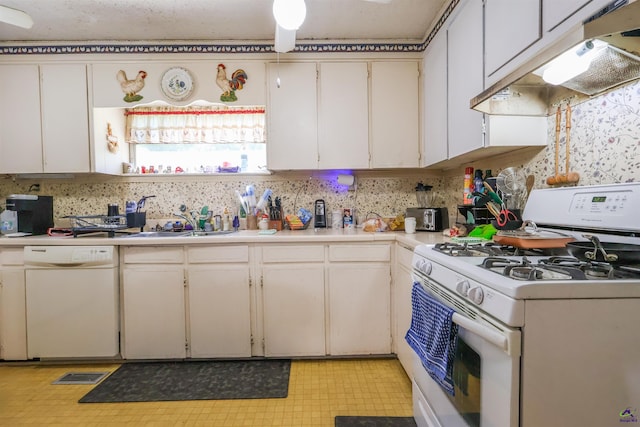 kitchen featuring white appliances, under cabinet range hood, light countertops, a sink, and light flooring