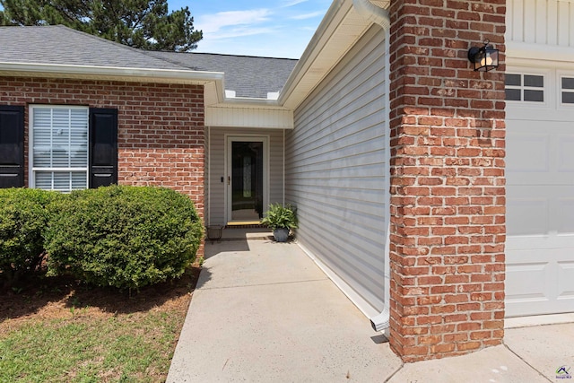 entrance to property with brick siding and roof with shingles