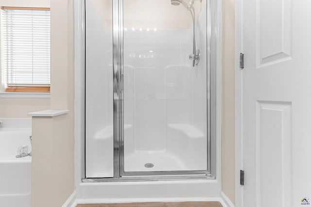 full bathroom with baseboards and a shower stall