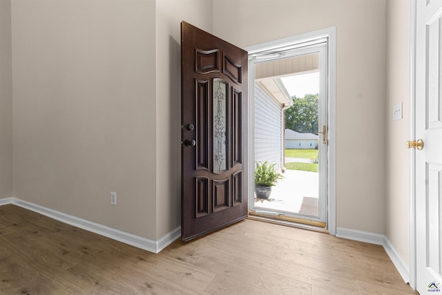 entrance foyer featuring light wood-type flooring and baseboards