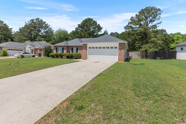 single story home featuring an attached garage, driveway, and brick siding